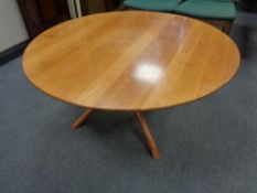 A circular pine low coffee table