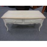 A Laura Ashley painted oak two drawer low coffee table on cabriole legs