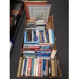 Three boxes containing assorted hard and soft cover books including novels, reference,