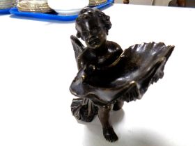 A 19th century patinated bronze putto holding an oyster shell-shaped dish (height 12cm)