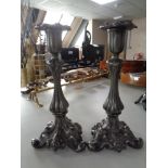 A pair of 19th century ornate pewter candlesticks