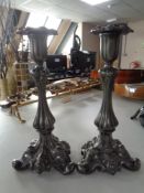 A pair of 19th century ornate pewter candlesticks