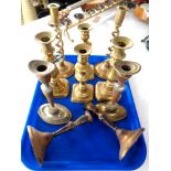 A tray of five pairs of brass candlesticks