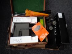 A box containing boxed projector and screen, pair of boots,