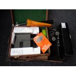 A box containing boxed projector and screen, pair of boots,