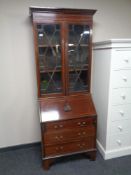 A late Victorian inlaid mahogany glazed bureau bookcase