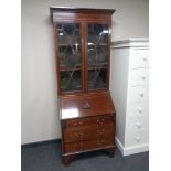 A late Victorian inlaid mahogany glazed bureau bookcase