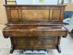 An antique walnut cased piano by Bishop & Son