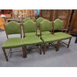 A set of six beech dining chairs in studded striped upholstery