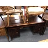 A continental teak writing desk fitted with four drawers beneath