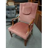 A continental beech framed armchair upholstered in pink Dralon