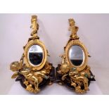 A pair of gilt-metal and marble mirrors in the form of lutes adorned with cherubs and foliage,