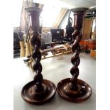 A pair of oak and pewter barley twist candlesticks