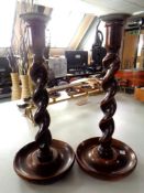 A pair of oak and pewter barley twist candlesticks