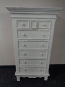 A contemporary white painted eight drawer chest together with similar bedside cabinet and small