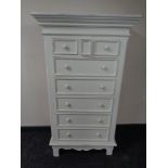 A contemporary white painted eight drawer chest together with similar bedside cabinet and small