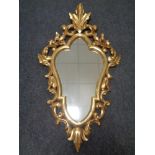 A decorative gilt framed Rococo-style wall mirror