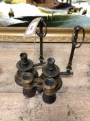 A pair of brass candlesticks and a small pair of binoculars