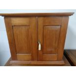 An Edwardian pine double door countertop cabinet with fitted internal shelves and drawers