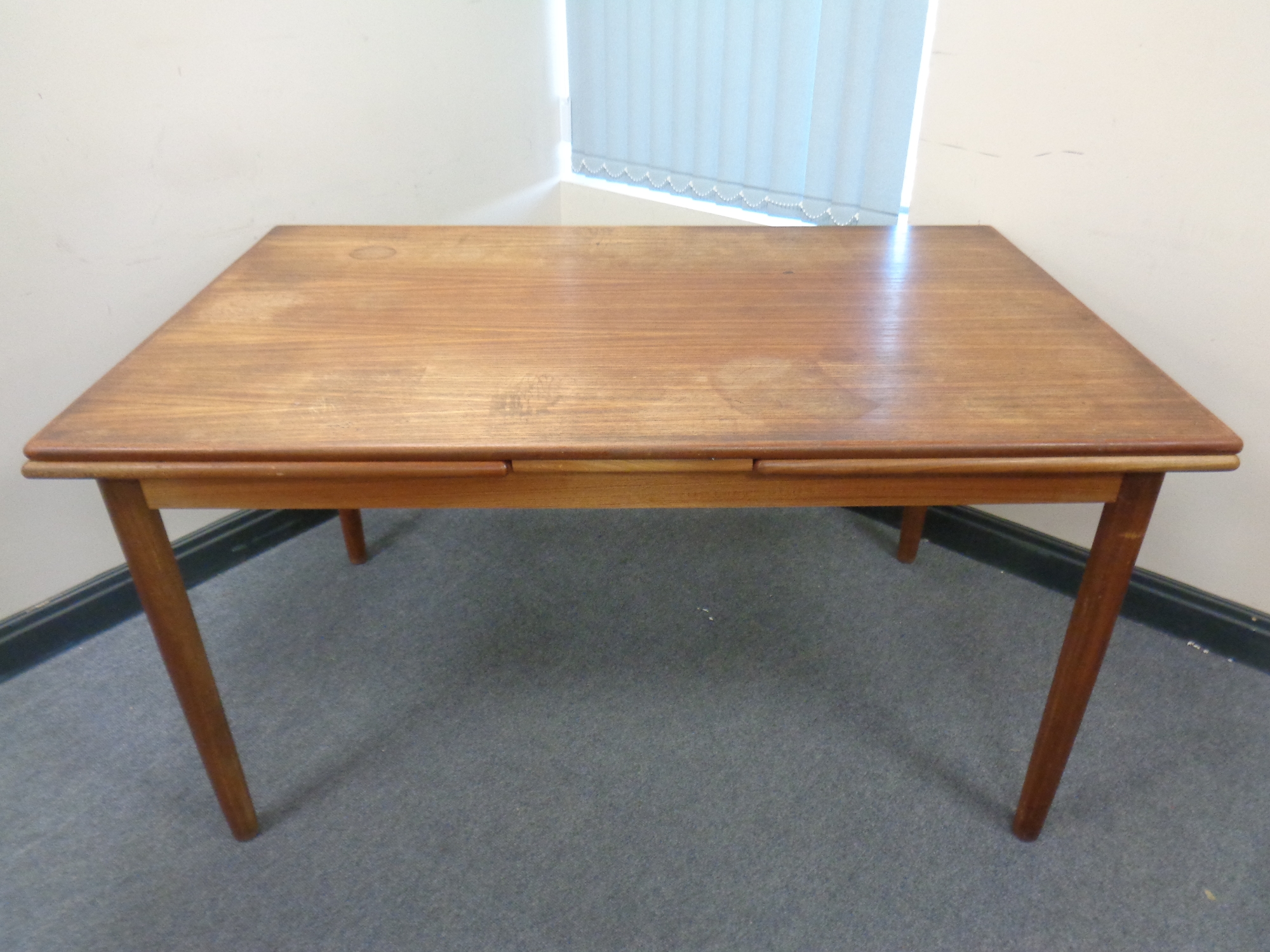 A 20th century teak pullout dining table