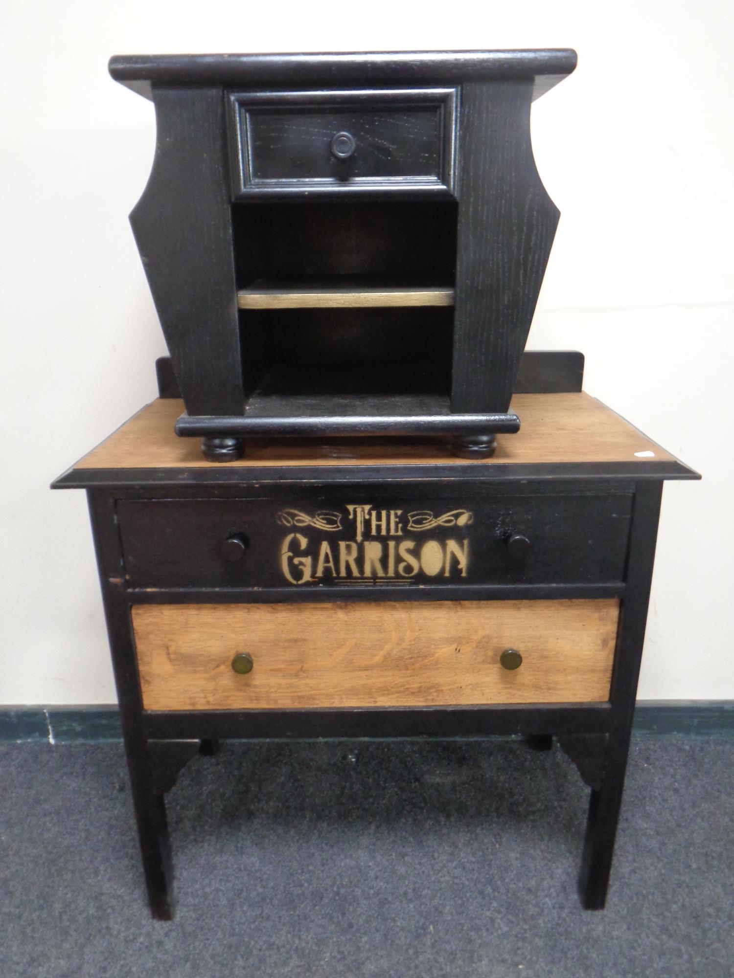 An oak two drawer chest and magazine rack with 'The Garrison Shelby Brothers' decoration