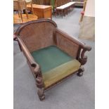 A late 19th century carved beech deep seated armchair (lacking cushion)