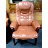 A brown leather upholstered armchair