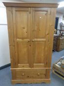 A contemporary pine double door wardrobe