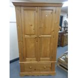 A contemporary pine double door wardrobe