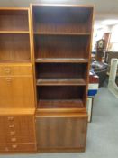 A 20th century rosewood veneered bookcase with fitted cupboard beneath