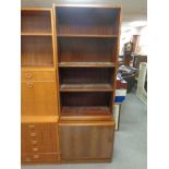A 20th century rosewood veneered bookcase with fitted cupboard beneath
