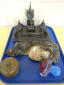A tray containing an Art Deco chalk wall mask female, an Edwardian ebonised desk stand,