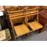 A set of four folding kitchen chairs