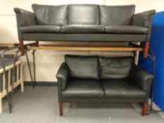A 20th century continental stained beech framed three seater settee upholstered in black leather
