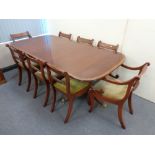 A Regency style inlaid mahogany twin pedestal dining table with leaf,