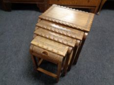 An oriental carved hardwood nest of four tables
