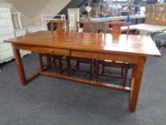 A stained pine farmhouse style table together with a set of six chairs