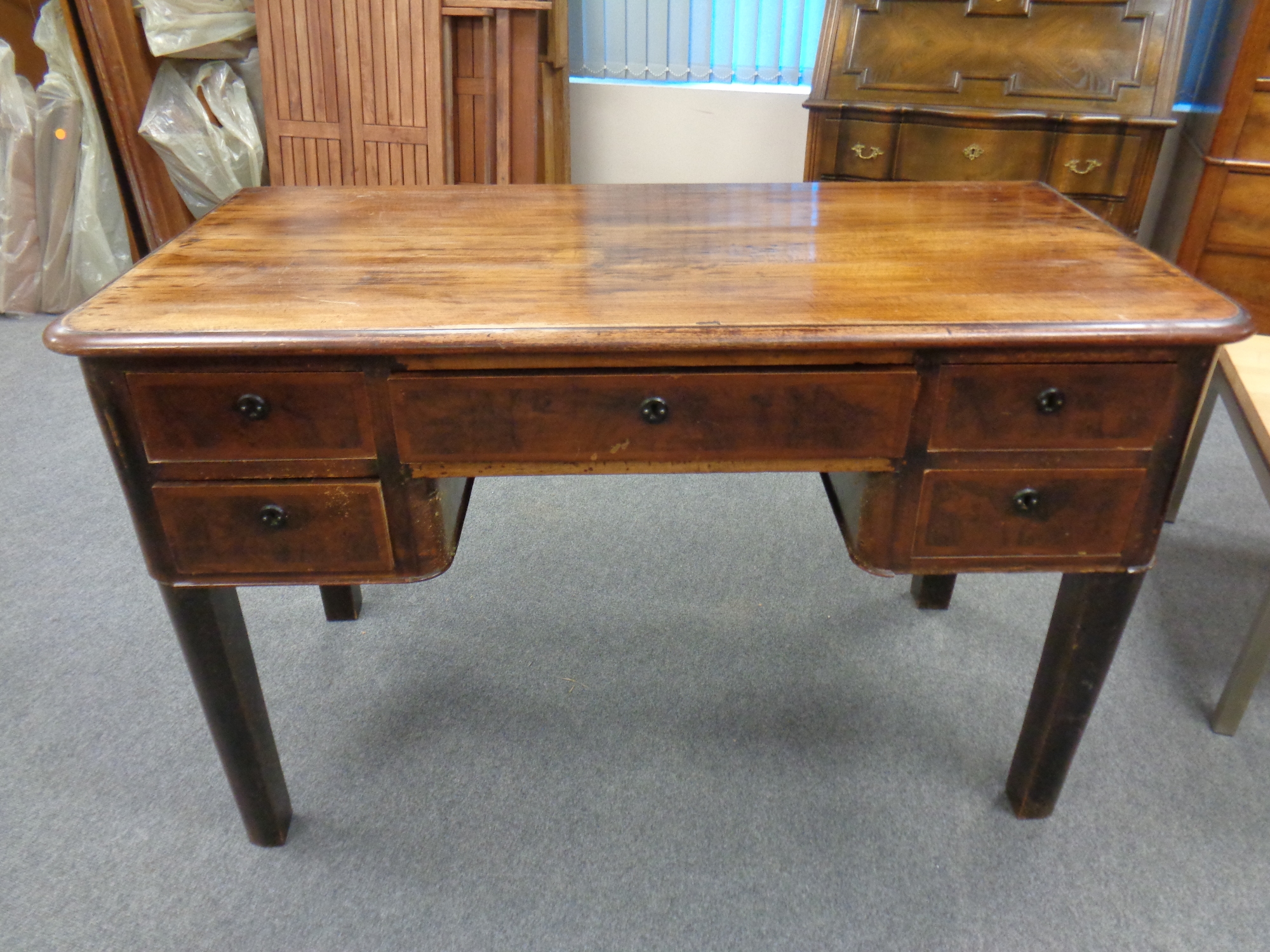 A antique continental beech writing desk fitted with five drawers