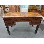 A antique continental beech writing desk fitted with five drawers