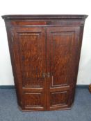 A George III oak corner cabinet