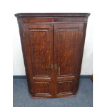 A George III oak corner cabinet