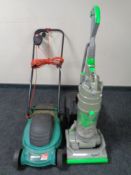 A Dyson DC 04 vacuum together with a Qualcast electric lawn mower