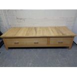A contemporary pine low storage table fitted with two drawers