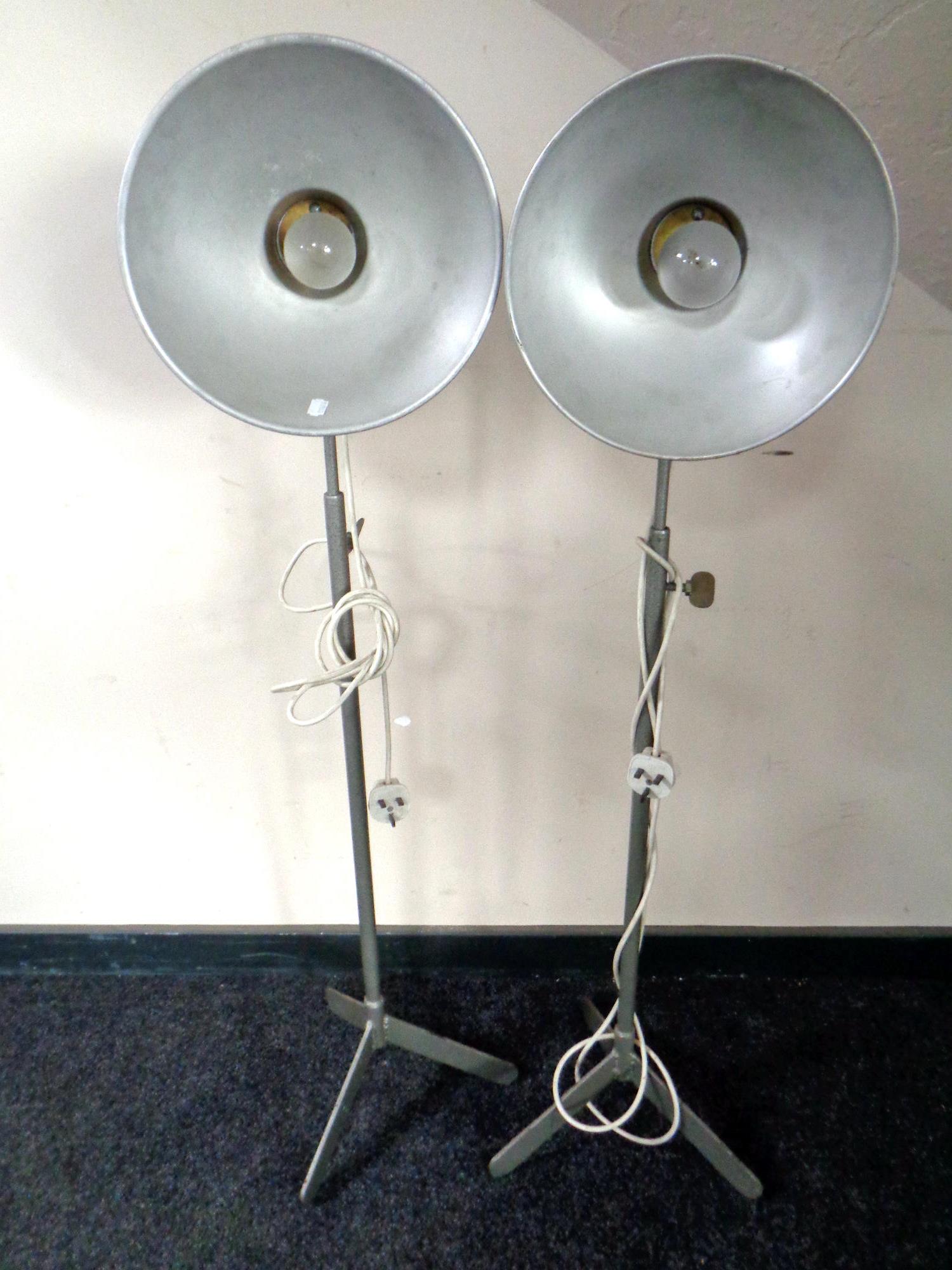 A pair of 20th century metal tripod standard lamps