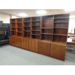 A 20th century rosewood veneer three part book case with fitted cupboards beneath (As found)