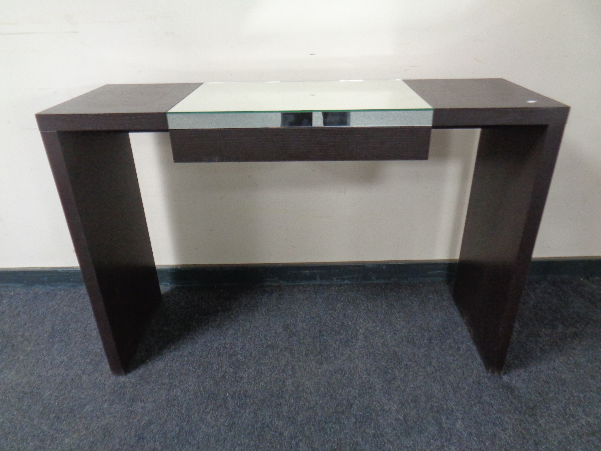 A contemporary dressing table with mirrored top