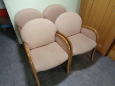 A set of four beech framed office armchairs