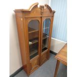 A 19th century continental oak and burr walnut glazed door bookcase