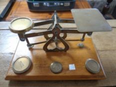 An antique set of postal scales with brass weights