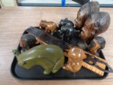 A tray of 20th century African carvings including busts, comb,